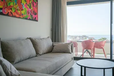a living room with a couch and a table at Sky-High 70sqm Penthouse w. Stunning Views - 05 in Chania Town
