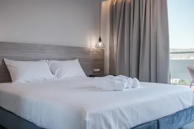 a bedroom with a white bed with towels on it at Sky-High 70sqm Penthouse w. Stunning Views - 05 in Chania Town