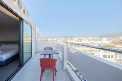 a balcony with a bed and a table and chairs at Sky-High 70sqm Penthouse w. Stunning Views - 05 in Chania Town