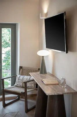 a room with a table with a tv on the wall at Theros Home in Chania Town