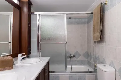 a bathroom with a shower and a sink and a toilet at Douranakis house Seaview Apartment in Chania Town