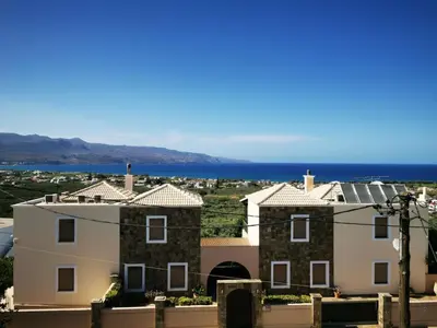 a view of a house with the ocean in the background at Douranakis house Seaview Apartment in Chania Town
