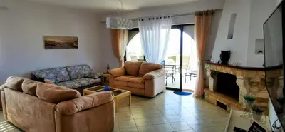 a living room with two couches and a fireplace at Douranakis house Seaview Apartment in Chania Town