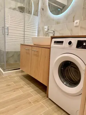 a bathroom with a washing machine and a sink at Paleochora Beach Studio (BRAND NEW) in Palaiochóra