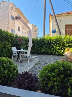a patio with a table and an umbrella at Estia Comfort House in Chania Town