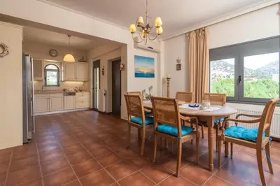 a kitchen and dining room with a table and chairs at Marika Seaside Villa in Yialós