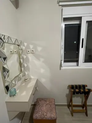 a bathroom with a sink and a mirror and a stool at Elia House in Chania Town