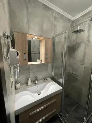 a bathroom with a sink and a shower at Elia House in Chania Town