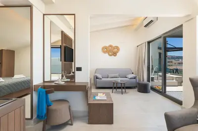 a living room with a couch and a table at Elia Agia Marina Resort in Agia Marina Nea Kydonias