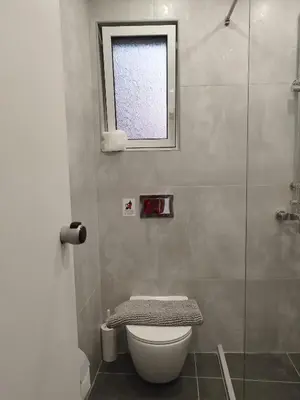 a bathroom with a toilet and a window at Villa Katerina in Chania Town