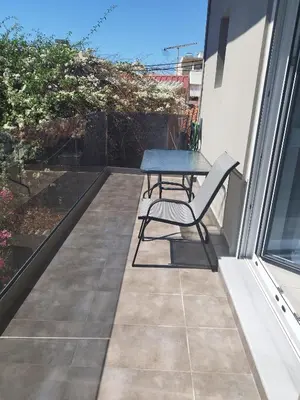a table and a chair on a balcony at Villa Katerina in Chania Town