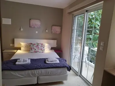 a bedroom with a bed and a large window at Villa Katerina in Chania Town