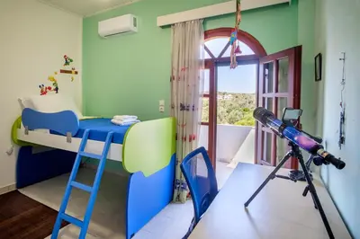 a bedroom with a bunk bed and a telescope at Villa Thalia Chania in Chania Town