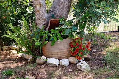 a large flower pot sitting next to a tree at Villa Thalia Chania in Chania Town