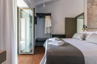 a bedroom with a large bed and a large mirror at Casa del Balo in Gavalomoúrion