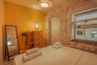 a bedroom with two white towels on a bed at Mourelo Home in Gavalochori