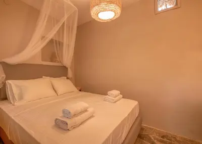 a bedroom with a bed with towels on it at Mourelo Home in Gavalochori