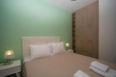 a bedroom with a bed with two towels on it at Korfali Apartments in Kissamos