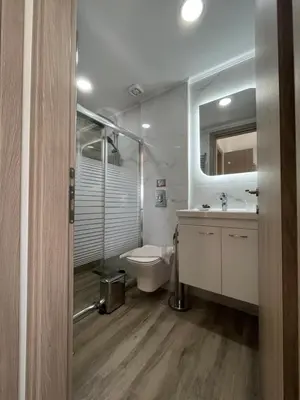 a bathroom with a shower and a toilet and a sink at Korfali Apartments in Kissamos
