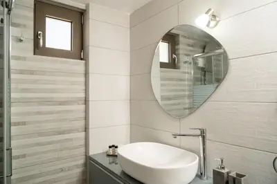 a bathroom with a sink and a mirror at Villa Emily in countryside in Chania Town