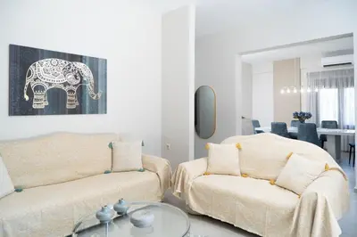 a living room with a couch and an elephant painting at Villa Emily in countryside in Chania Town