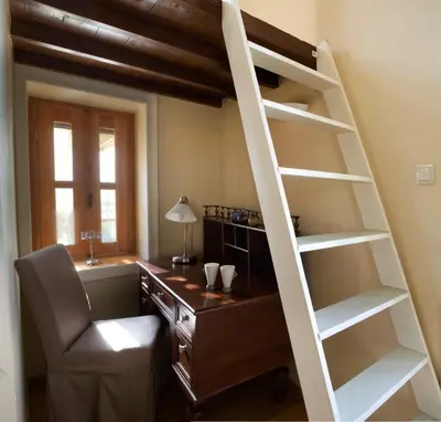 an office with a desk and a loft ladder at Dorothy's Dream in Chania Town