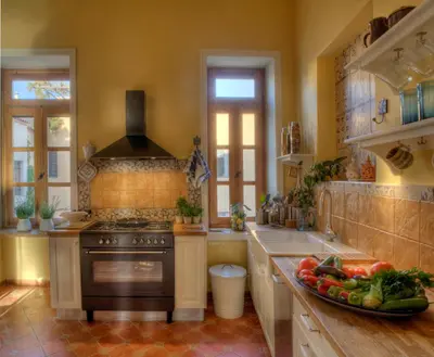 a kitchen with a stove and a plate of vegetables at Dorothy's Dream in Chania Town