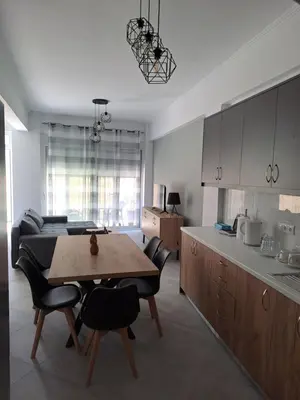 a kitchen with a table and a dining room at Parthenon apartment in Souda