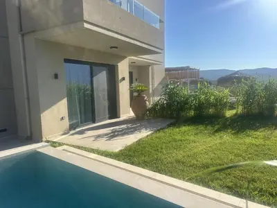 a house with a yard with a swimming pool at Nusa Retreat - Seaview luxury residences - ideal for groups in Kissamos