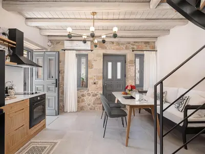 a kitchen and dining room with a table and chairs at La Canea Living in Chania Town