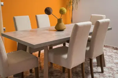 a dining room table with chairs and a vase on it at Somine Apartment Chania in Chania Town