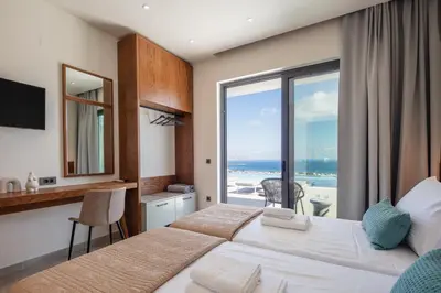 a hotel room with a bed and a view of the ocean at Magical new luxury villa Camellia! in Kissamos