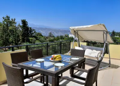 a table with a bowl of fruit on a balcony at Souda Bay View with Private Pool near Chania City in Chania Town