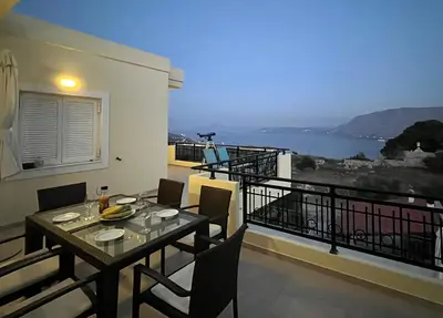 a table and chairs on a balcony with a view at Souda Bay View with Private Pool near Chania City in Chania Town