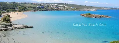 a view of a beach with blue water at Souda Bay View with Private Pool near Chania City in Chania Town