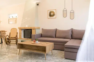 a living room with a couch and a table at Searenity Home in Ropanianá