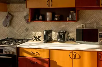 a kitchen with a stove and a microwave at Searenity Home in Ropanianá
