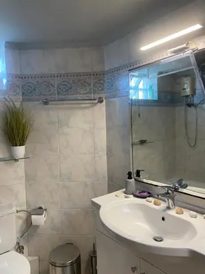a bathroom with a sink and a mirror at Searenity Home in Ropanianá