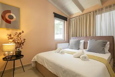 a bedroom with a bed with towels on it at Boutique house Romantza in Kallithea-Voukolies