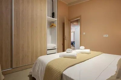 a bedroom with a bed with towels on it at Boutique house Romantza in Kallithea-Voukolies