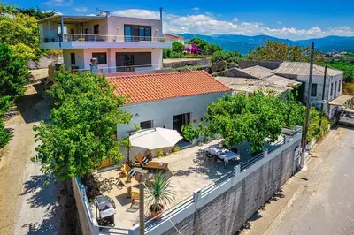 an overhead view of a house with a table and an umbrella at Boutique house Romantza in Kallithea-Voukolies