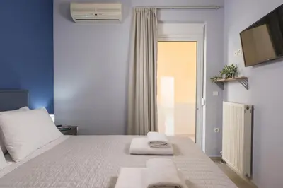 a bedroom with a white bed with towels on it at Casa Del Sol-Halepa- in Chania Town