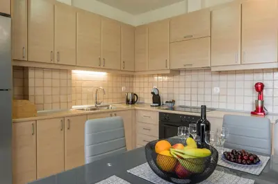 a kitchen with a bowl of fruit on a counter at Casa Del Sol-Halepa- in Chania Town