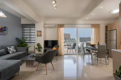 a living room with a couch and a table at Casa Del Sol-Halepa- in Chania Town