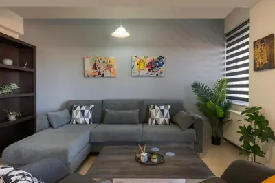 a living room with a couch and a table at Casa Del Sol-Halepa- in Chania Town