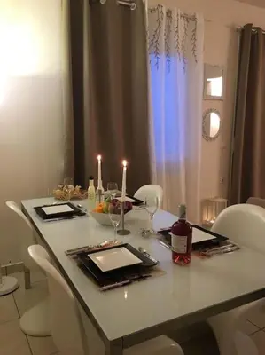 a dining room table with candles on it with chairs at Sea View Apartment #2 in Stalos