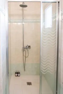 a shower with a glass door in a bathroom at Kadiani's Residence by 8essentially in Chania Town