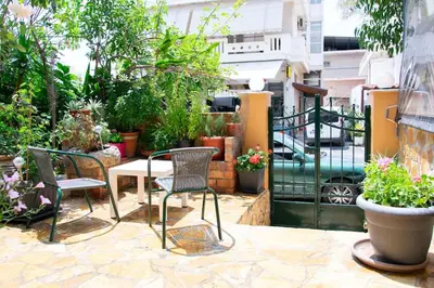 a patio with two chairs and a table with plants at Kadiani's Residence by 8essentially in Chania Town