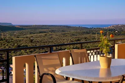 a table with a vase with a flower on a balcony at Iconic Villa with private pool and sea view in Próvarma