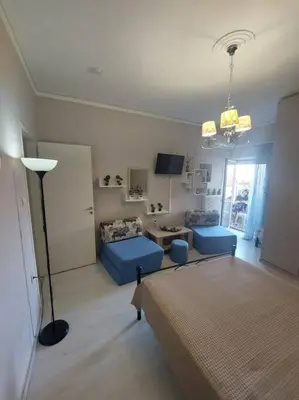 a living room with a bed and a couch and a table at Koum Kapi 1st floor apt in Chania Town